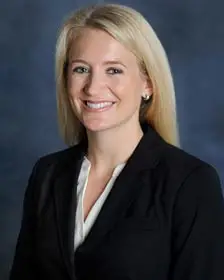 Ashlea Wehle, a trademark professional smiling in a black blazer and a white blouse.